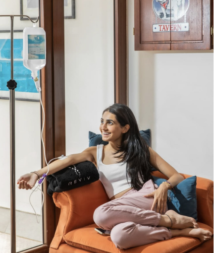 Woman receiving IV therapy at home from REVIV Hyderabad